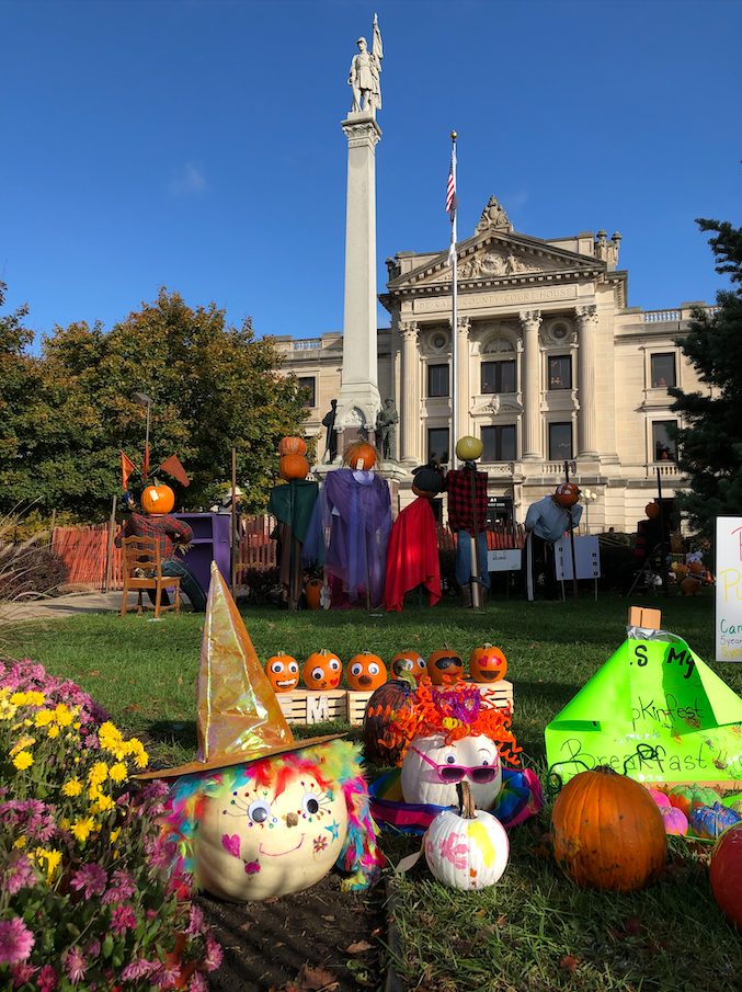 The DeKalb County Courthouse during Pumpkin Festival in downtown Sycamore with decorated pumpkins on the courthouse lawn.